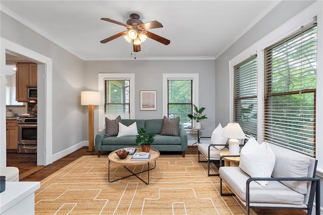 628 Home Ave SE, Atlanta, GA 30312 - living room with healthy amount of natural light, a ceiling fan, light wood-style floors, ornamental molding, and baseboards