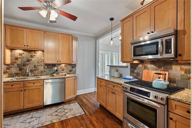 628 Home Ave SE, Atlanta, GA 30312 - kitchen with stainless steel appliances, a sink, a ceiling fan, decorative backsplash, and baseboards