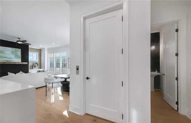 hall with light hardwood / wood-style flooring