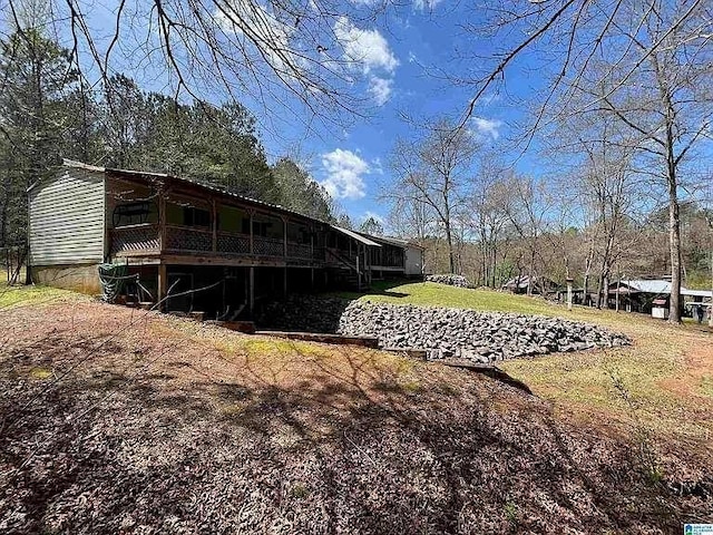 rear view of property featuring a deck