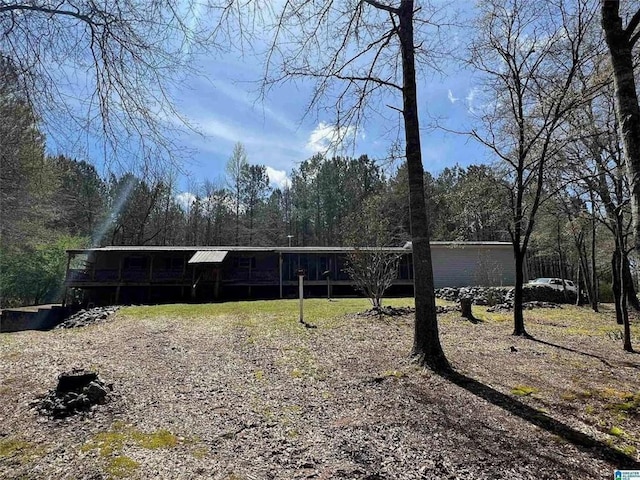 exterior space featuring a deck and a forest view