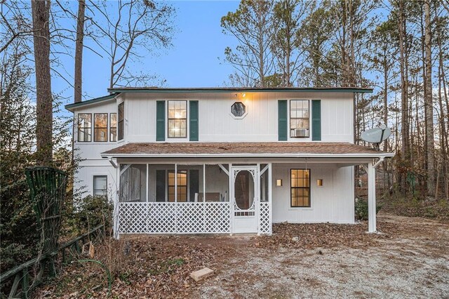 view of front of house featuring a sunroom and cooling unit