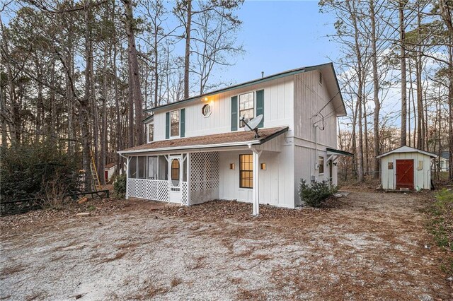 view of front of property featuring a storage shed