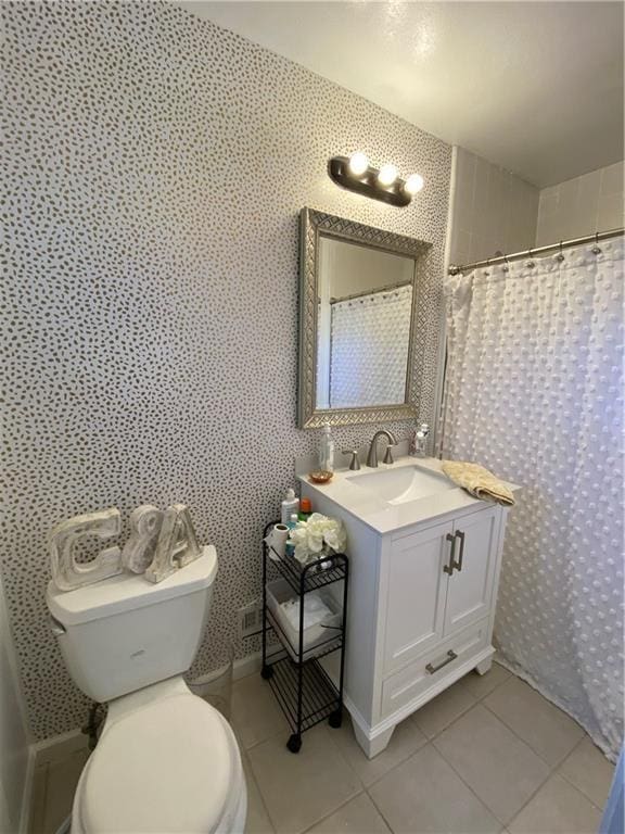 bathroom with curtained shower, vanity, toilet, and tile patterned floors