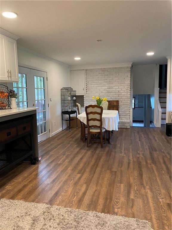 dining space with recessed lighting, dark wood-type flooring, baseboards, stairs, and crown molding