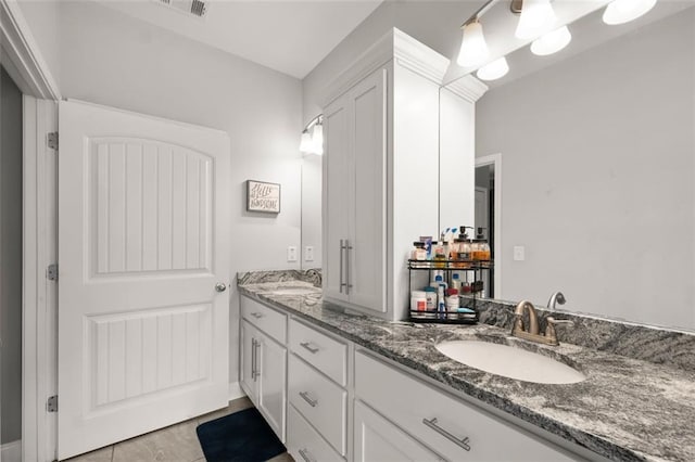 bathroom featuring tile patterned flooring and vanity