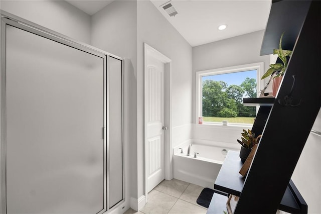 bathroom featuring tile patterned floors and independent shower and bath