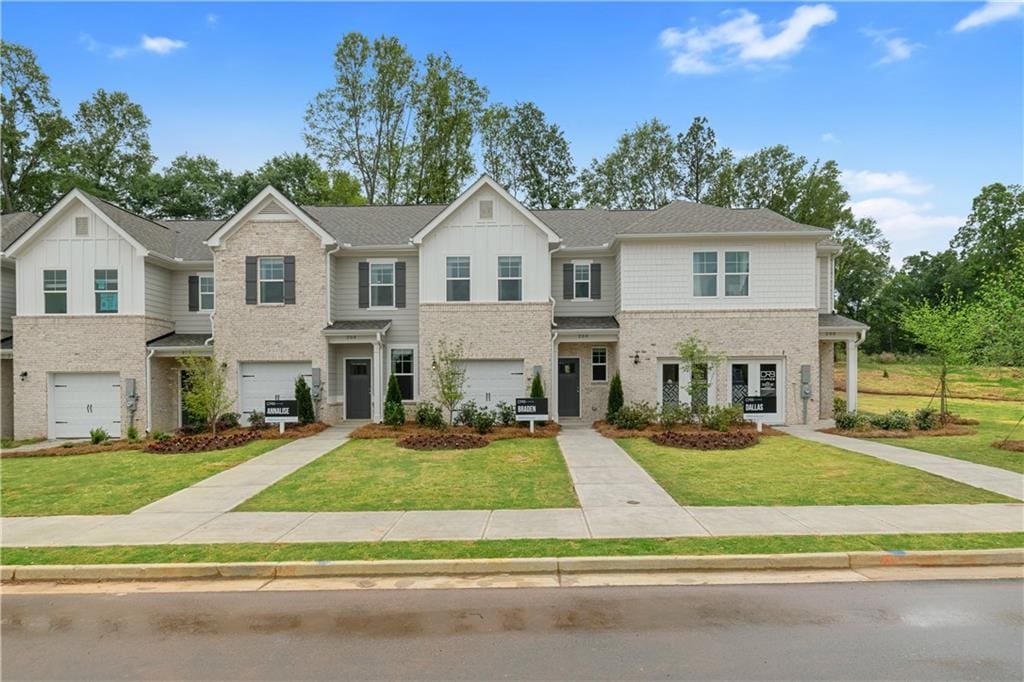 view of front of property featuring french doors, a garage, and a front lawn