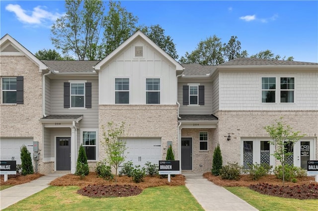 view of front of property with a garage and a front lawn