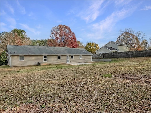 rear view of property with a yard and a patio area