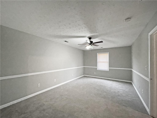 unfurnished room with ceiling fan, carpet floors, and a textured ceiling