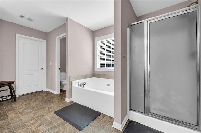 full bathroom featuring baseboards, a stall shower, toilet, and a bath