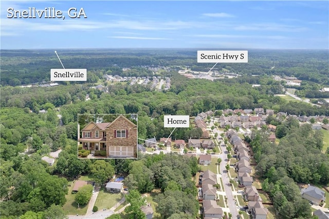 birds eye view of property featuring a view of trees and a residential view