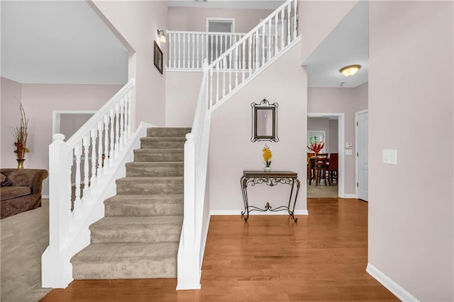 stairs with baseboards and wood finished floors