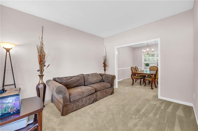 carpeted living room featuring baseboards and a chandelier