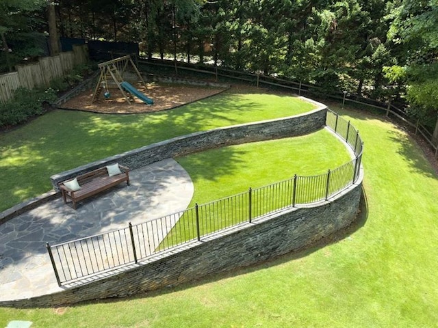 view of home's community featuring a playground and a lawn