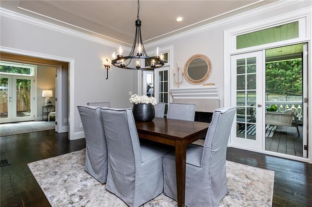 dining room featuring dark wood-type flooring, a wealth of natural light, french doors, and crown molding