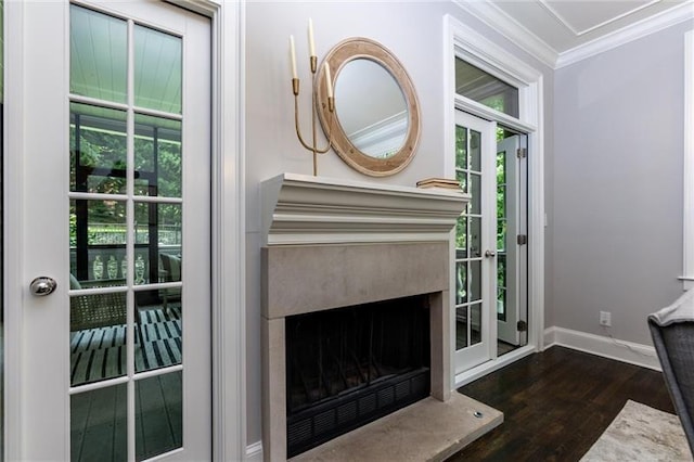 doorway to outside with a fireplace, dark wood-type flooring, and ornamental molding