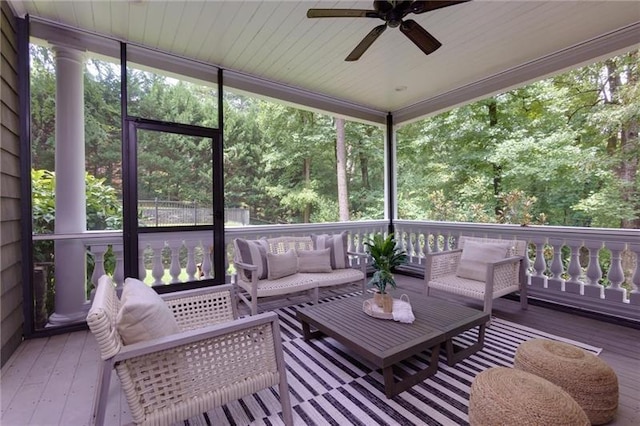 sunroom / solarium featuring plenty of natural light and ceiling fan