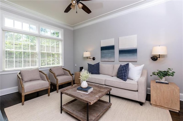 living room featuring hardwood / wood-style floors, ceiling fan, and crown molding