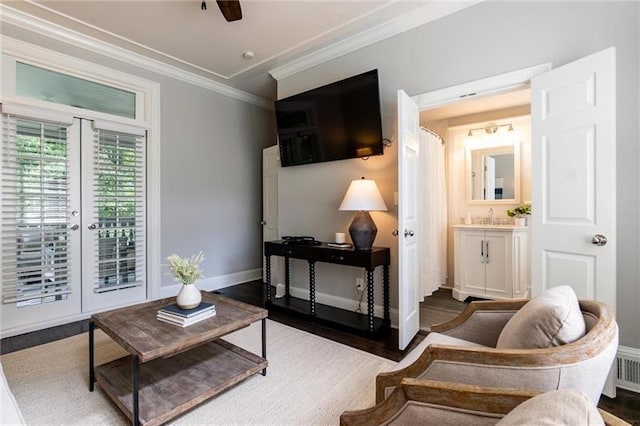 living room featuring hardwood / wood-style flooring, ceiling fan, and crown molding