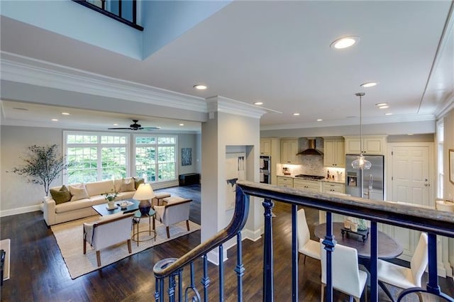 living room featuring ceiling fan, dark hardwood / wood-style floors, and ornamental molding