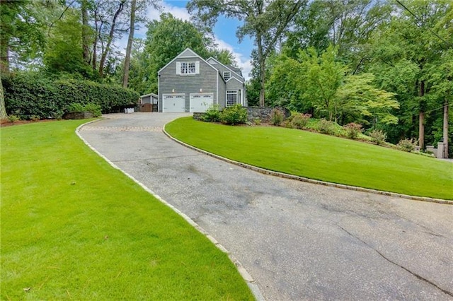 view of home's exterior with a garage and a lawn