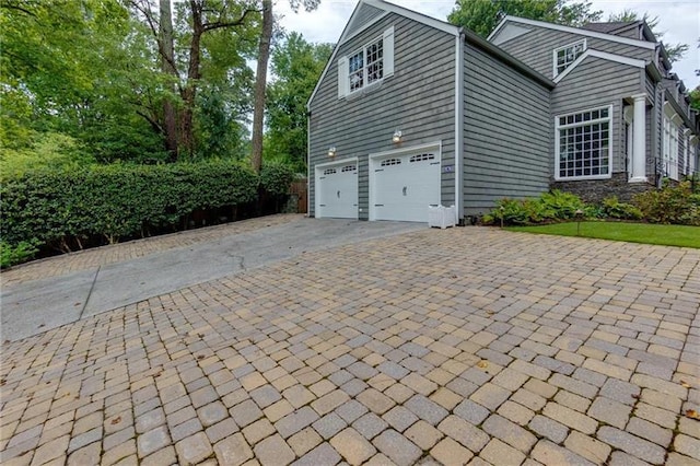 view of side of home with a garage