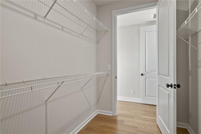 spacious closet featuring hardwood / wood-style floors