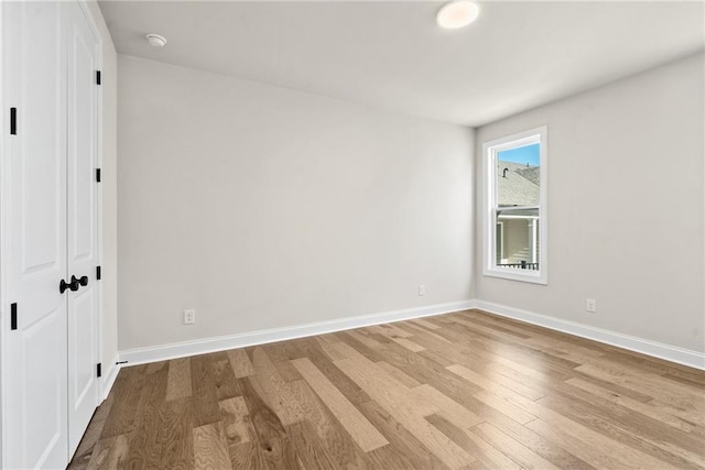 unfurnished bedroom with a closet and light hardwood / wood-style flooring