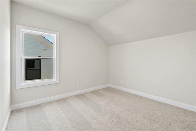 bonus room with lofted ceiling and carpet floors