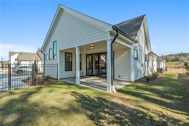 back of house featuring a yard and a patio area