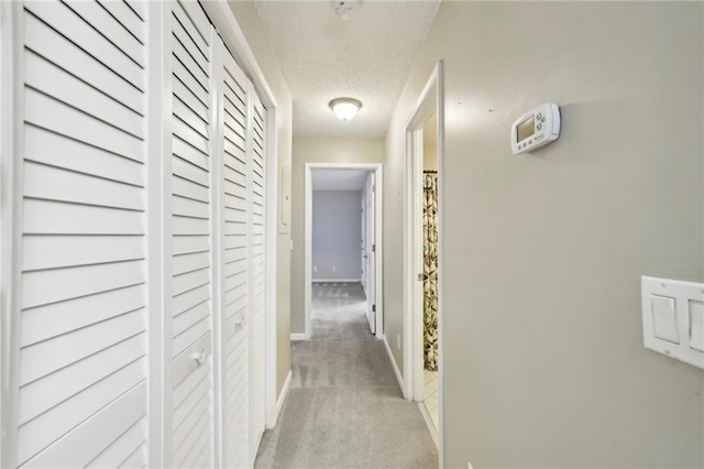 511 Barrington Hills Dr, Atlanta, GA 30350 - hallway with a textured ceiling, light carpet, and baseboards