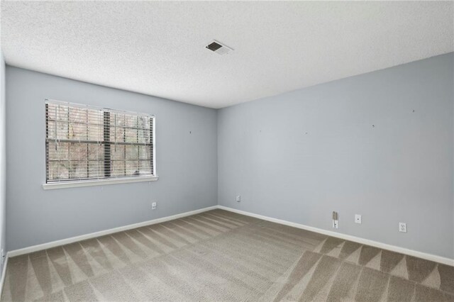 511 Barrington Hills Dr, Atlanta, GA 30350 - spare room with carpet, a textured ceiling, and baseboards