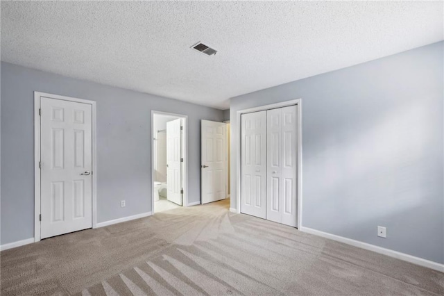 511 Barrington Hills Dr, Atlanta, GA 30350 - unfurnished bedroom featuring carpet floors, baseboards, a textured ceiling, a closet, and connected bathroom