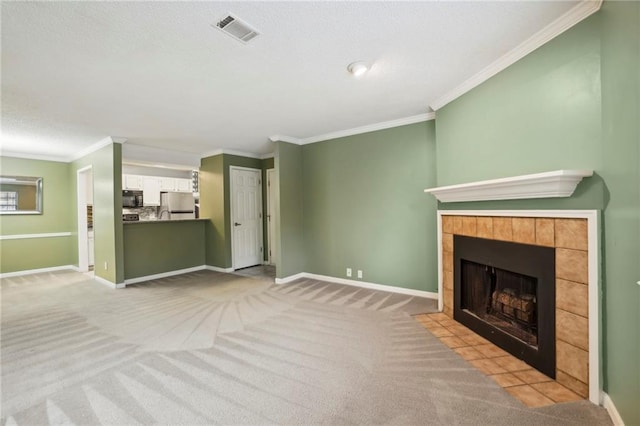 511 Barrington Hills Dr, Atlanta, GA 30350 - unfurnished living room featuring crown molding, a tiled fireplace, baseboards, light colored carpet, and a textured ceiling