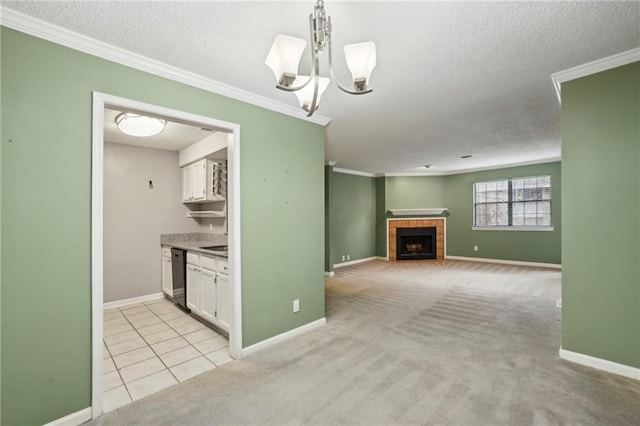 511 Barrington Hills Dr, Atlanta, GA 30350 - kitchen featuring dishwasher, white cabinets, a textured ceiling, crown molding, and a tile fireplace
