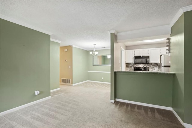 511 Barrington Hills Dr, Atlanta, GA 30350 - kitchen featuring black appliances, crown molding, white cabinetry, a chandelier, and light carpet