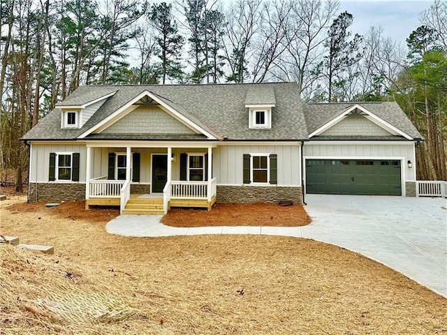 craftsman-style house featuring driveway, a porch, a garage, stone siding, and board and batten siding