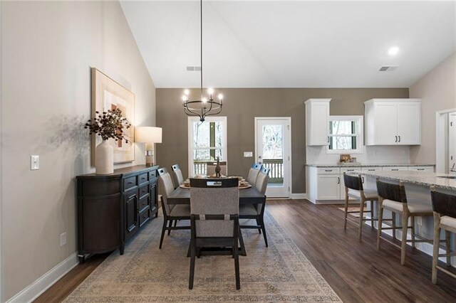 dining room with dark wood finished floors, visible vents, and plenty of natural light