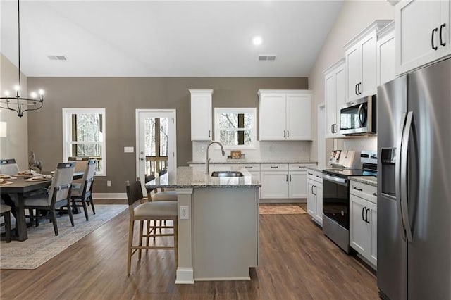 kitchen featuring visible vents, white cabinets, appliances with stainless steel finishes, and a sink