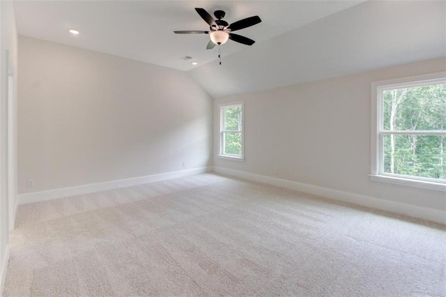 empty room featuring lofted ceiling, recessed lighting, carpet, and baseboards