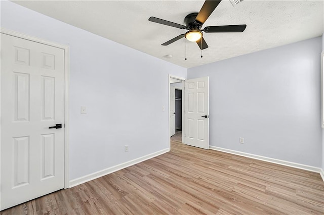 unfurnished room with ceiling fan and light wood-type flooring