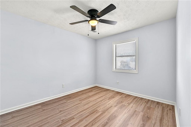 spare room featuring a textured ceiling, ceiling fan, and light hardwood / wood-style floors