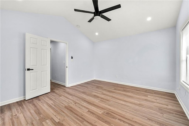 spare room featuring ceiling fan, vaulted ceiling, and light hardwood / wood-style flooring