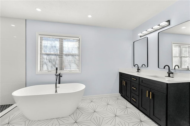 bathroom featuring a bath and vanity