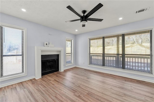 unfurnished living room featuring ceiling fan and light hardwood / wood-style floors