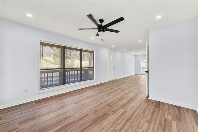 empty room featuring ceiling fan and light hardwood / wood-style flooring