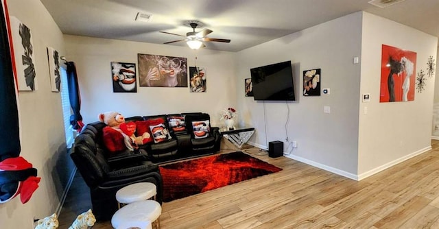 living room with ceiling fan and hardwood / wood-style floors