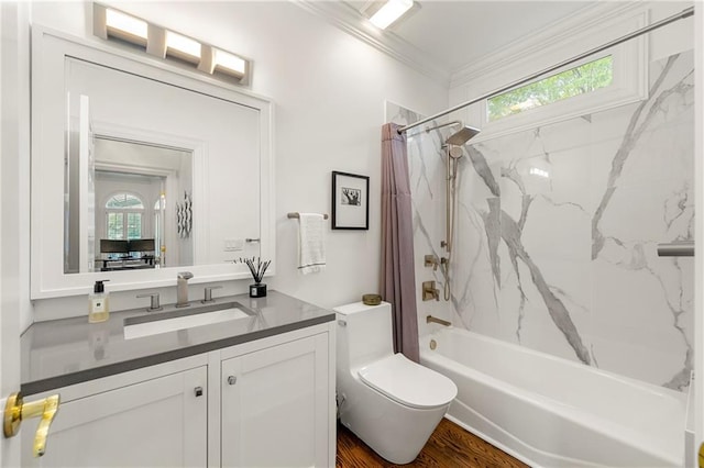 full bathroom featuring hardwood / wood-style floors, ornamental molding, shower / bath combo with shower curtain, vanity, and toilet